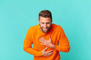 young handsome man laughing out loud at some hilarious joke