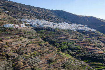 Fototapeta na wymiar View across white village on the slope of mountain in the Sierra Nevada, Las Alpujarras, Granada Province, Spain