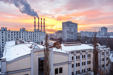 Winter or spring Moscow landscape at sunrise. Buildings of residential area and pipes of heat station. Problems of cold, heating, global warming and environmental pollution