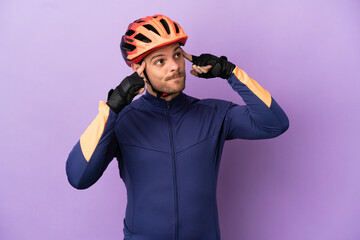 Young Brazilian cyclist man isolated on purple background having doubts and thinking