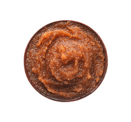 Bowl of brown body scrub isolated on white, top view