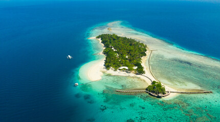 Little Liguid Island with beautiful beach, palm trees by turquoise water view from above. Little Cruz Island, Philippines, Samal.