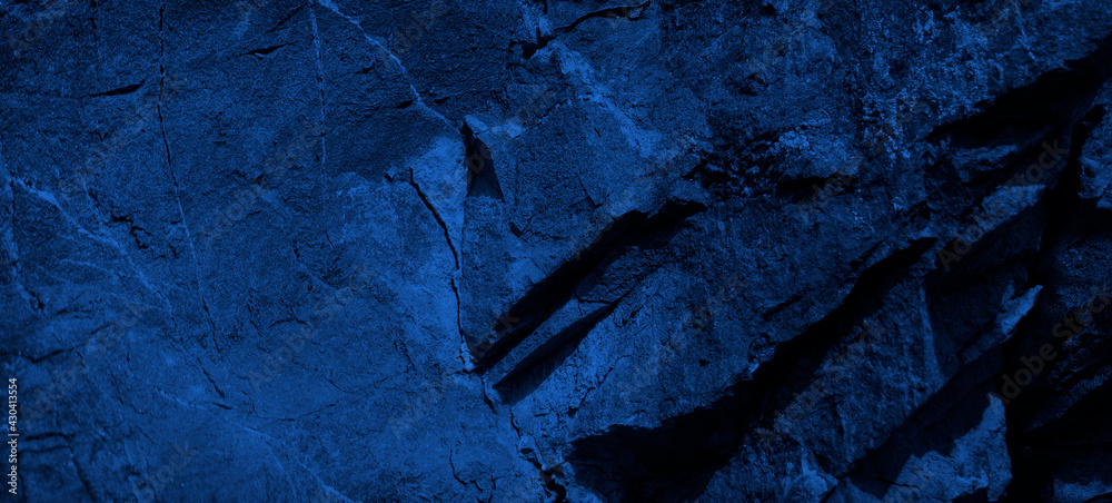 Wall mural dark blue stone background. toned rock texture background with copy space for design. web banner.