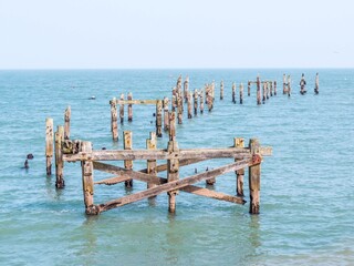 delipidated remains of an old pier in the sea