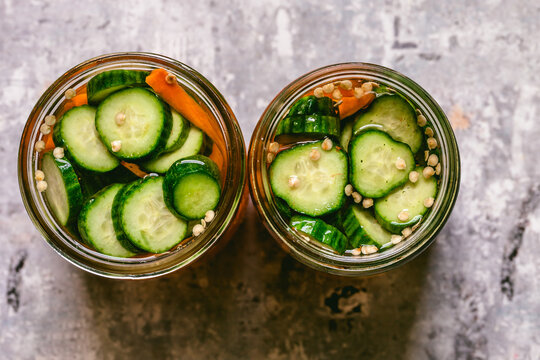 pickled carrots, cucumbers, and jalape&ntilde;os in glass jars. 