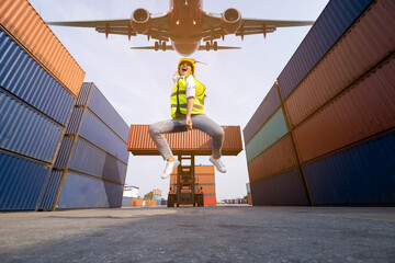  asian women foreman  jumping over in work area warehouse container and air plane background ....
