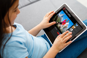 little girl watching travel videos online. Child watching a video about the trip with his family