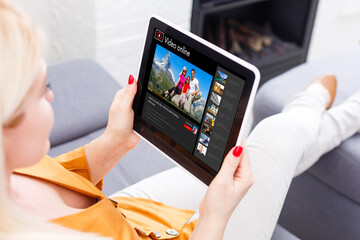 Happy woman planning vacations on line searching information in a laptop in a resort or hotel.