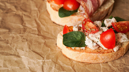 Three fresh bruschetta on craft paper. Delicious snack