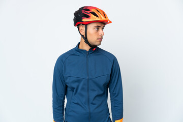 Young cyclist Brazilian man isolated on white background looking to the side