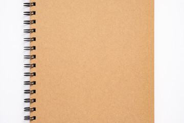 Close up, top view of brown color blank paper cover spiral notebook, copy space for your text.