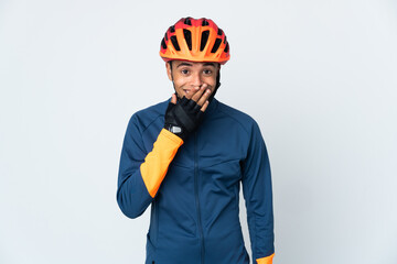Young cyclist Brazilian man isolated on white background happy and smiling covering mouth with hand