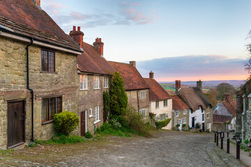 Fototapeta na wymiar Sunset over cottages on a cobbled street