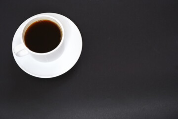 Black coffee  on a black background.