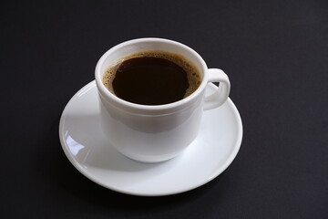 Black coffee  on a black background.