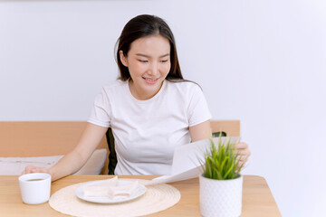 Asian woman eating lunch while working from home