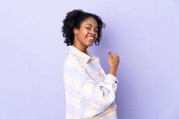 Young African American woman isolated on purple background proud and self-satisfied
