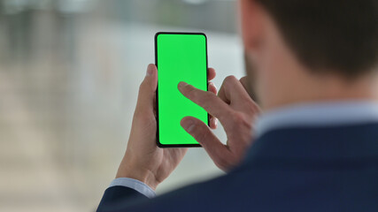 Middle Aged Businessman using Smartphone with Chroma Screen 