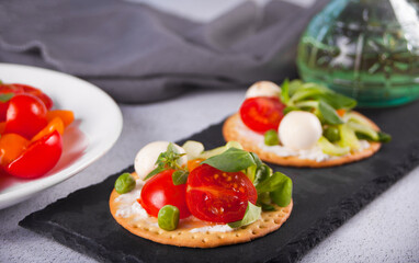 Round crispbread toast with greens and vegetables. Healthy food concept.