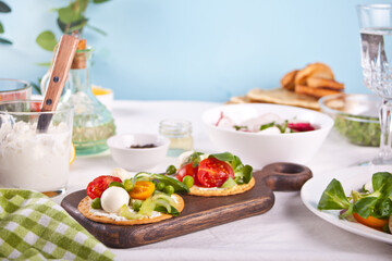 Round crispbread toast with greens and vegetables. Healthy food concept.
