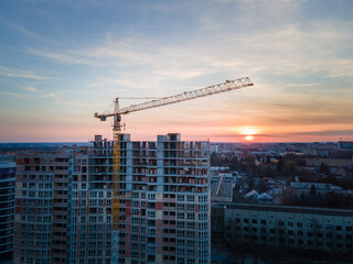 aerial view of apartment construction site with crane