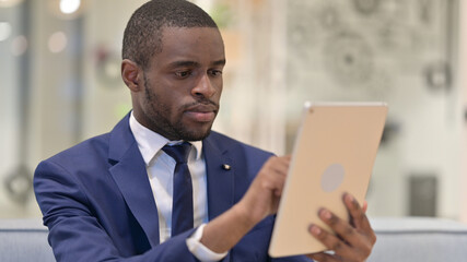 Portrait of African Businessman using Digital Tablet