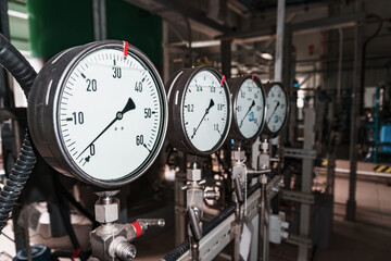 Pressure gauge is a close-up pressure measuring device in a row.
