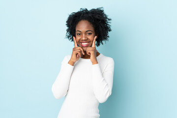 Fototapeta na wymiar Young African American woman isolated on blue background smiling with a happy and pleasant expression