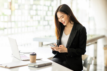 Portrait of Accounting businesswoman working on note laptop computer and analyzing real estate investment data, Financial and tax systems concept.