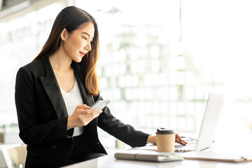 Portrait of Accounting businesswoman working on note laptop computer and analyzing real estate investment data, Financial and tax systems concept.