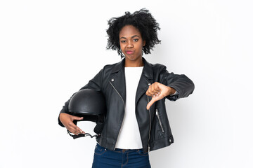 Young African American woman with a motorcycle helmet isolated on white background showing thumb...