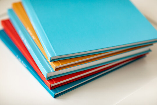 pyramid of multicolored books or photo albums. Place for the inscription. selling photographer's services or printing.