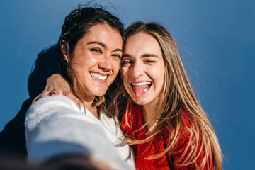 Couple of young girls smiling while taking a selfie