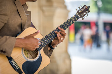 Detail of latin man playing guitar in the street