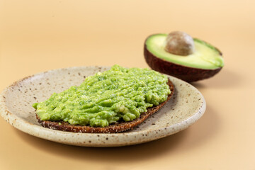 A healthy sandwich with fresh avocado and rye brown bread. Half an avocado. Healthy eating. Concept.