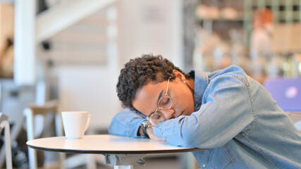 Exhausted African Woman taking Nap in Cafe 