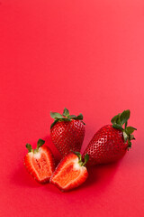 Strawberry. Fresh strawberries on a red background. Red on red. Place for your text. Copy space.