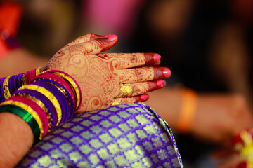 Hands of bride is decorated beautifully by indian mehndi art along with jewelery’s and colorful bangles