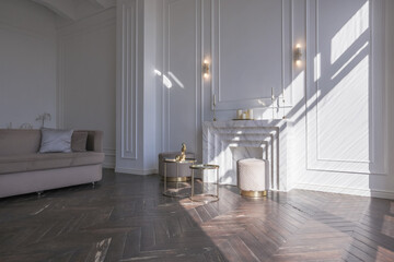 very light and bright interior of luxurious cozy living room with chic soft beige furniture with gold metallic elements, huge window to the floor and wooden parquet