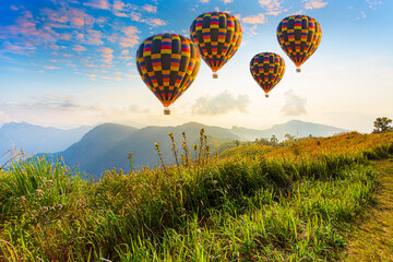 Beautiful balloons and mountains,Hot air balloons and mountains and beautiful sky,Colorful hot-air balloons flying over the mountain and sea of mist, Doi Inthanon Natural Park Chiang Mai, Thailand