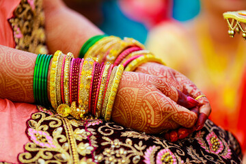 Hands of bride is decorated beautifully by indian mehndi art along with jewelery’s and colorful bangles