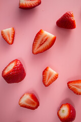 Delicious juicy ripe red strawberries on a pink background. Close-up shot of strawberries on a grater. Berry pattern