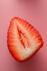 Delicious juicy ripe red strawberries on a pink background. Close-up shot of strawberries on a grater. Macro shot of garden strawberry