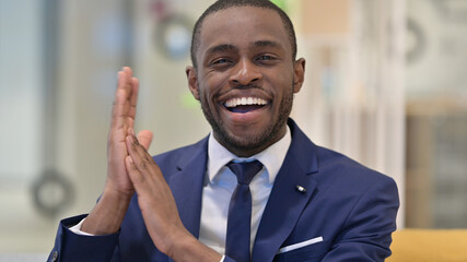 Portrait of Excited African Businessman Clapping 