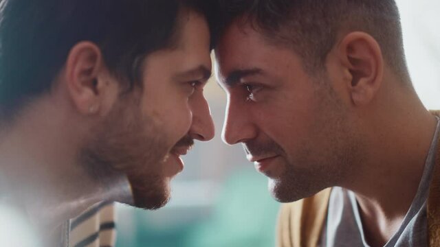 Authentic Close Up Footage of a Stylish Handsome Young Adult Gay Couple Spend Time at Home. Two Happy Men in Love in Casual Clothes Make a Gentle Headbutt. Cute LGBT Relationship Content.