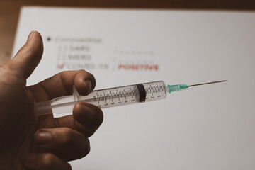 
the covid vaccine.
syringe containing coronavirus vaccine