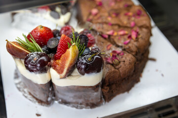 Fruit cake decorated with figs, cookies and blueberries