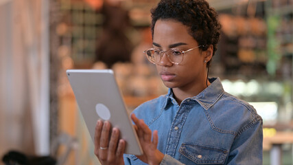 Portrait of Serious African Woman using Digital Tablet