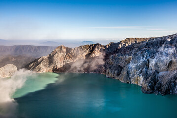 Ijen volcano crater with lake and sulphur mining. Beautiful Landscape mountain and green lake with...