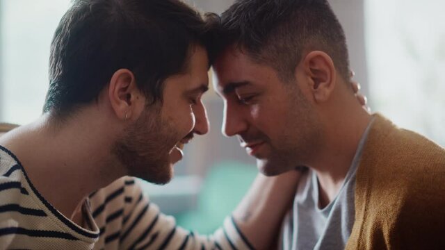 Authentic Close Up Footage of a Stylish Handsome Young Adult Gay Couple Spend Time at Home. Two Happy Men in Love in Casual Clothes Make a Gentle Headbutt. Cute LGBT Relationship Content.